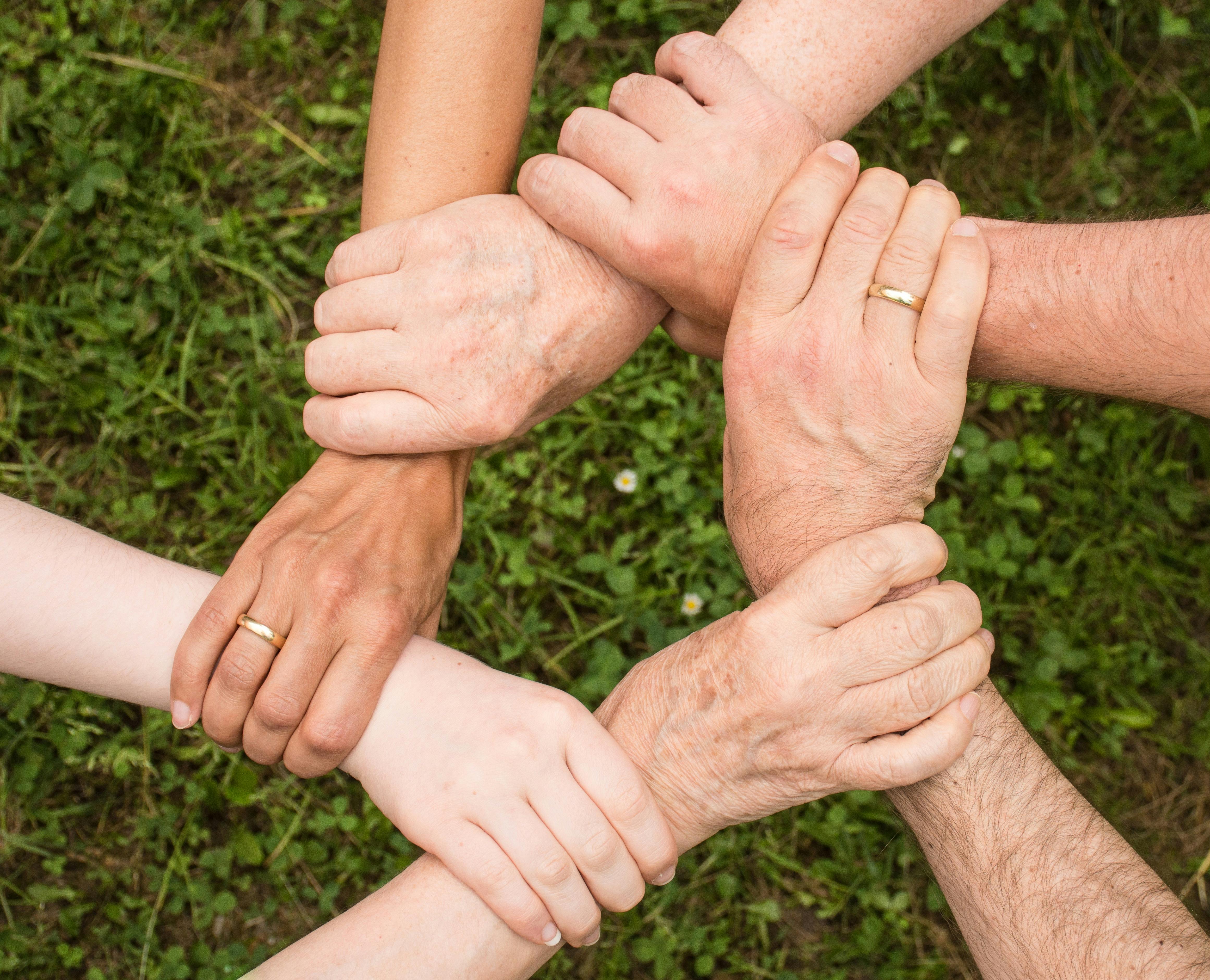 Hands holding onto one another